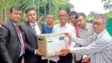 The image shows Tripura Horticulture Assistant Director Dr Dipak Baidya handing over pineapples at Akhaura land port in Brahmanbaria on Sunday, June 23, 2024.