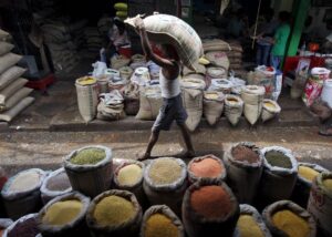 FILE PHOTO: A labourer carries a sack filled with pulses at a wholesale pulses market in Kolkata, India, July 31, 2015. REUTERS/Rupak De Chowdhuri/File photo