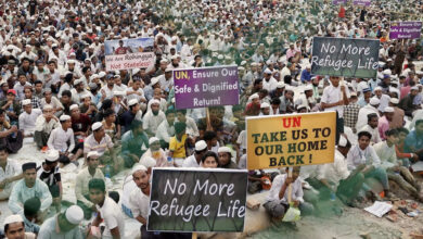 Rohingya refugees hold placards while attending a Ramadan Solidarity Iftar to have an Iftar meal with United Nations Secretary-General Antonio Guterres and Muhammad Yunus, Chief Adviser of Bangladesh Interim Government, at the Rohingya refugee camp in Cox's Bazar, Bangladesh, March 14, 2025. Photo: REUTERS/Mohammad Ponir Hossain/File Photo
