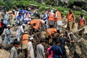Flood survivors assist rescue personnel to remove heavy rocks and clear remains of damaged buildings in the Buner district of mountainous Khyber Pakhtunkhwa province on August 17, 2025. (AFP)