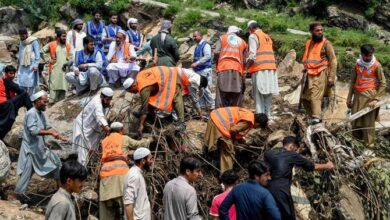 Flood survivors assist rescue personnel to remove heavy rocks and clear remains of damaged buildings in the Buner district of mountainous Khyber Pakhtunkhwa province on August 17, 2025. (AFP)