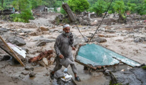 A resident evacuates the area following a rise in floodwaters in the Buner district of Pakistan's Khyber Pakhtunkhwa province on August 18, 2025. (AFP)