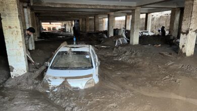People struggle to retrieve cars from mud after devastating floods in Pakistan’s Khyber Pakhtunkhwa province. Photo: Xinhua