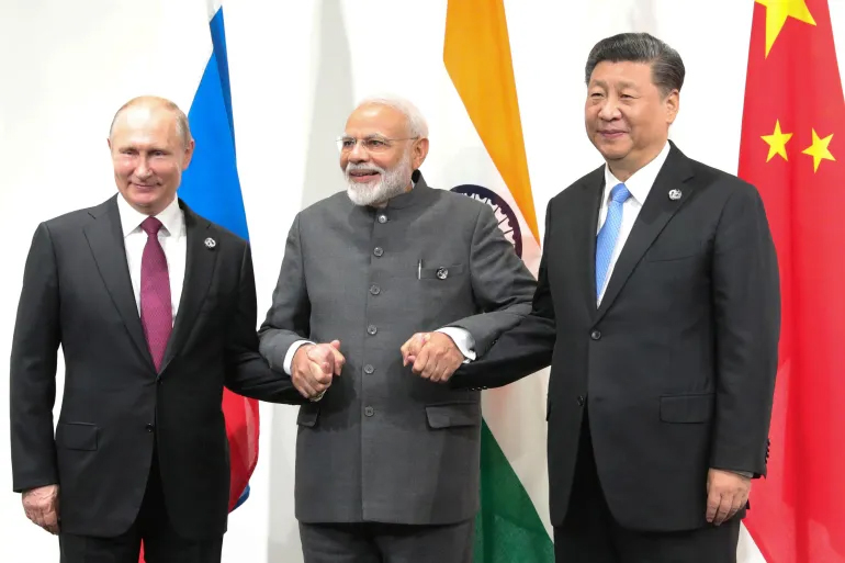Russian President Vladimir Putin, Indian Prime Minister Narendra Modi and Chinese President Xi Jinping hold a meeting on the sidelines of the G20 summit in Osaka on June 28, 2019 [Mikhail Klimentyev/Sputnik/ AFP]