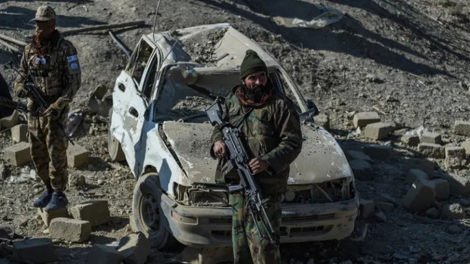 Taliban security personnel stand guard near a damaged car two days after air strikes by Pakistan in Paktika province on 26 December 2024. File Photo: AFP via BSS