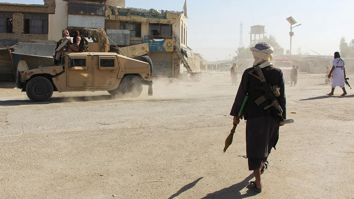 Taliban security personnel on a Soviet-era tank are followed by motorcyclists as they ride towards the border, as clashes take place between Taliban security personnel and Pakistani border forces on Wednesday. Photo: TNS