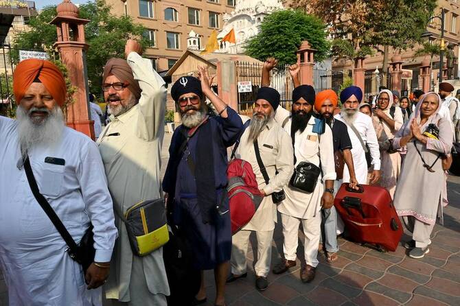 Sikh pilgrims gesture as they queue up to board a bus leaving for Pakistan during the ‘Baisakhi’ spring harvest festival in Amritsar on April 10, 2025. (AFP file photo)