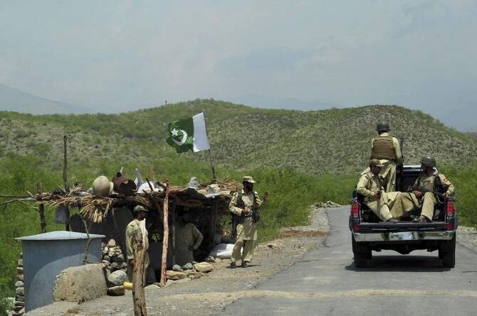 Above, Pakistani paramilitary forces ride past a checkpoint in Manatu mountain in Kurram. (AFP file photo)