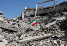 An Iranian flag stands in the rubble following a strike on a police station in Tehran, Iran, March 4. Photo: Reuters